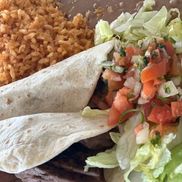 Los Charros' burrito with rice, refried beans, shredded lettuce, and pico de gallo.